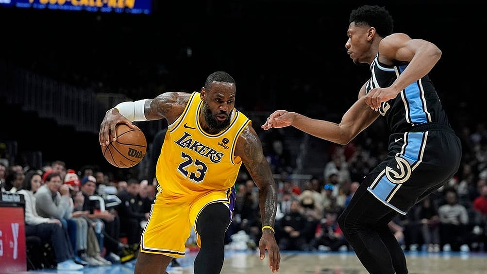 Photo: AP/John Bazemore : NBA: LeBron James (left) in action for Atlanta Hawks vs LA Lakers.